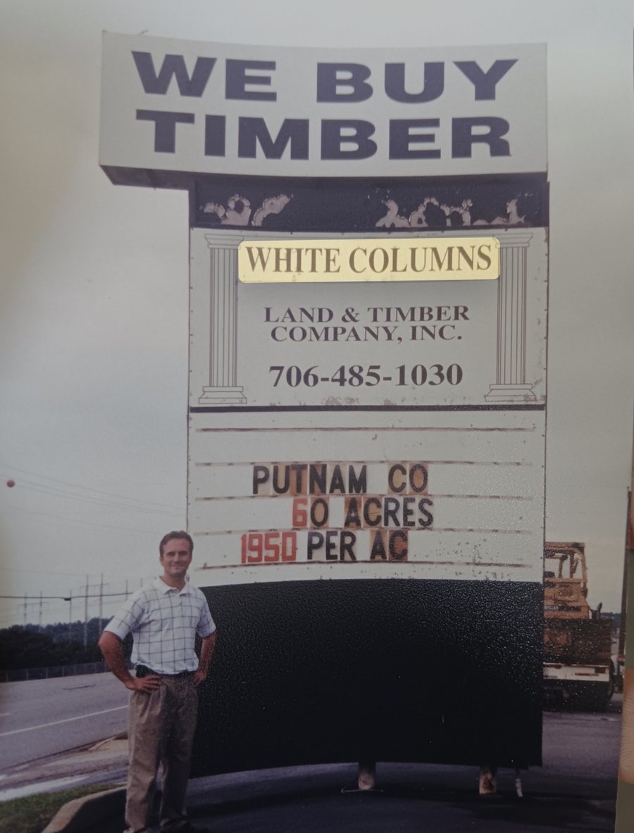 A young DJ Snipes at the White Columns Land & Timber Company sign, 2003